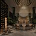 Four Seasons Hotel New Orleans lobby with circular bar, hanging chandelier and lounge seating