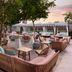 Outdoor lounge at the goodtime hotel, Miami Beach, a Tribute Portfolio Hotel with poolside seating at sunset