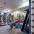 Hôtel Colbert Palace gym in Antananarivo with exercise machines, mirrors and stability balls
