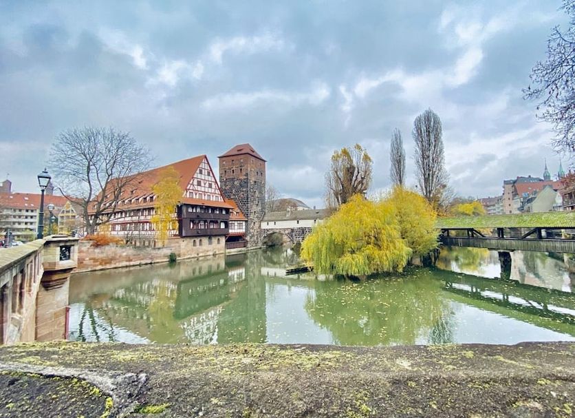 Burghotel Nürnberg in Nuremberg with castle moat, bridge, and riverside town view