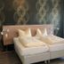 Hotel Markgräfler Hof in Badenweiler guest room with two single beds and patterned wallpaper