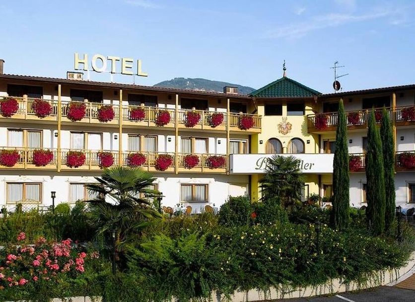 Gardenhotel Premstaller in Bolzano with flowered balconies and landscaped garden courtyard
