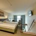 Arass Hotel & Business Flats Antwerp guest room with twin beds and city-view window
