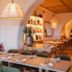 Casa Bassa in Valencia dining room with arched openings, pendant lights, and set tables