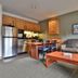 Killington Grand Resort Hotel in Killington: a suite with kitchenette, dining table, sofa, coffee table and floor lamp