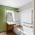 WoodSpring Suites San Antonio South bathroom with shower, toilet, and sink in San Antonio