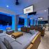 Hilton Garden Inn San Juan Condado terrace lounge with blue-lit pool and ocean view in San Juan