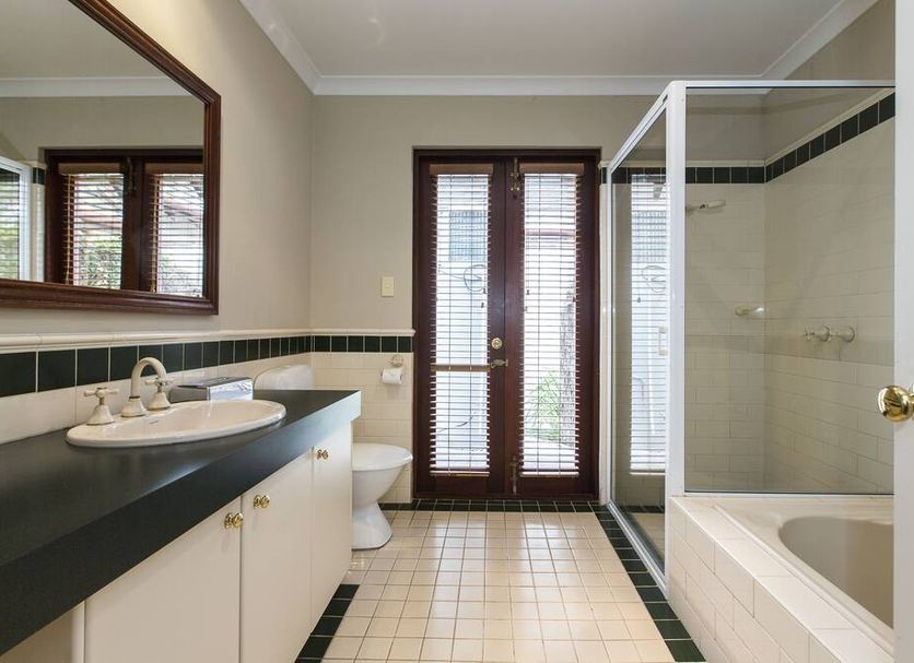 Margaret River Resort bathroom with vanity, toilet, glass shower and French doors to balcony in Margaret River