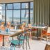 The Relais Cooden Beach in Bexhill-on-Sea dining room with sea view through large windows