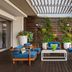 Cape Town Marriott Hotel Crystal Towers outdoor lounge with blue chairs, coffee table, and vertical garden in Cape Town