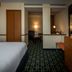 Fairfield Inn & Suites by Marriott Tupelo guest room with bed, desk, and sitting area