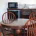 Texas Inn And Suites At La Joya kitchenette with round table, chairs, mini fridge, sink and microwave