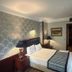 Boutique Princess Hotel Istanbul guest room with a double bed, bedside lamps, and patterned wallpaper