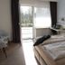 Hotel zum Rosenteich in Bad Zwischenahn guest room with twin beds and balcony door