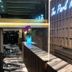 The Park Residence in Bangkok lobby with marble reception desk, striped seating, and hanging pink flowers