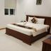 Volga Apartment Hotel in Mũi Né guest room with a bed, windows, and simple white tile flooring