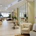 Rizzi Aquacharme Hotel & Spa lobby lounge in Darfo Boario Terme with armchairs, mirrors, and floral decor