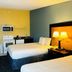 Regency Inn & Suites New London Mystic guest room with two beds, microwave, and mini fridge in New London