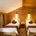 Sanqingshan Jinshawan Holiday Hotel Shangrao twin room with wood-paneled walls and two beds