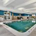 Indoor pool area at Hampton Inn Buffalo - Amherst in Amherst with lounge seating and large windows
