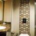 Bella Hotel Istanbul bathroom vanity with granite countertop, round sink and patterned tile accent wall