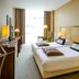 Fletcher Hotel Restaurant Amersfoort room with twin beds, desk, and floor-to-ceiling window