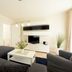 Hotelanlage Tarnewitzer Hof in Ostseebad Boltenhagen living room with sofa, TV and coffee table