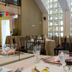 Dining room at Isabella Boutique Hotel in San Pedro Sula with tall grid windows and set tables