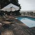 Dwór Sieraków in Sieraków, Małopolskie with a small outdoor pool, loungers, and countryside views