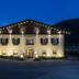 Hotel Lener in Mauls, illuminated hotel exterior at night with mountain backdrop