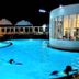 River City Hotel in Mukdahan featuring a lit outdoor pool at night with swimmers