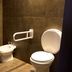 Esplendor Buenos Aires bathroom with bidet, toilet, towel rack and dark tiled walls in Buenos Aires