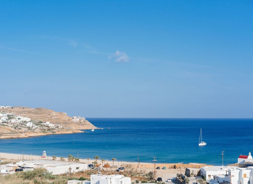 Penelope Village in Kalafati with sea view over a blue bay and distant cliffs