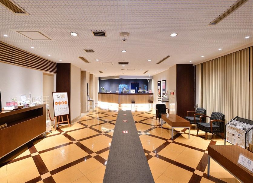 Chisun Hotel Koriyama lobby with check-in counter, seating area, and patterned floor in Kōriyama