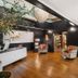 Hotel Mountain Brook Tannersville lobby with wood floors, black walls, seating, and glass door to greenery