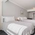 Trafalgar Lodge, Nelson guest room with two beds and simple gray decor