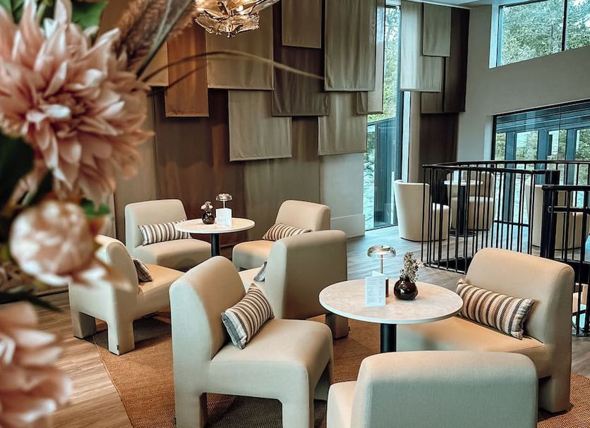 Vann Spa Hotell & Konferens in Brastad lounge with cream chairs, round tables and floor-to-ceiling windows