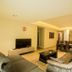 Accra Fine Suites in Accra living room with sofa, TV, coffee table and dining area