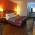 Motel 6 Clarksville Tn guest room with king bed, bedside lamps, desk and seating area in Clarksville