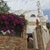 La Caleta de Tamariu in Tamariu with bougainvillea-covered stone wall and hotel sign
