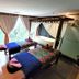 The Palace Hotel Kota Kinabalu spa room with two massage beds beside large curtained windows