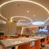 ibis Styles Lima Benavides Miraflores dining area with orange chairs and modern ceiling lights
