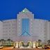 Holiday Inn Express Pensacola Beach by IHG exterior at dusk with illuminated facade and palm trees