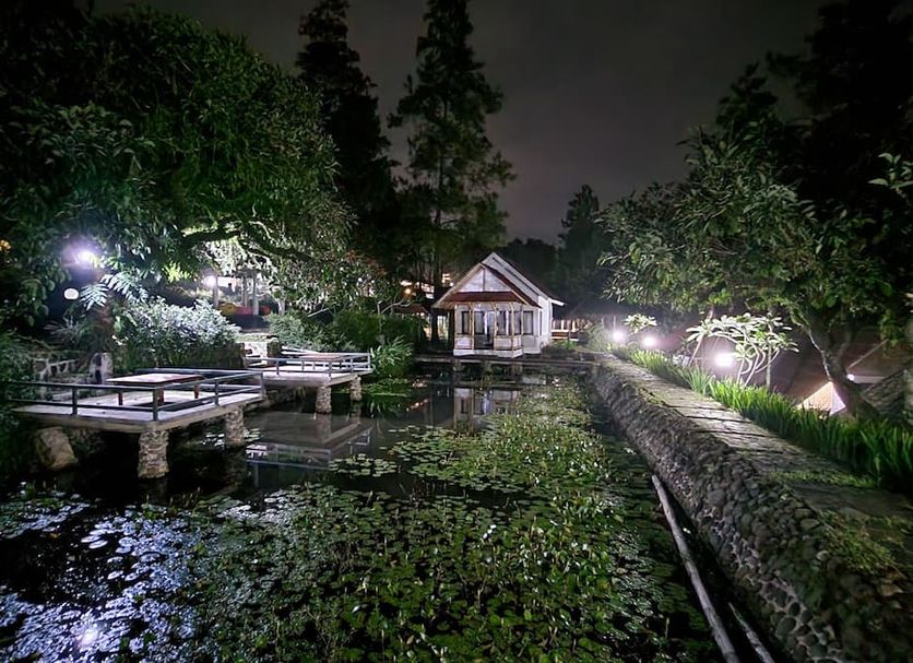 Bukit Alamanda Resort in Garut: night garden pond with wooden bridges and a small pavilion