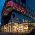 Sheraton Zibo Hotel in Zibo with illuminated modern glass facade at dusk