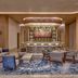 Waldorf Astoria Riviera Maya lounge in Cancún with bar, seating area, and abstract wall art