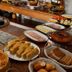 Villa Montserrat in Campos do Jordão buffet table with pastries, sliced bread, fruit, eggs, and baked dishes