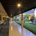 Covered walkway at Lombok Garden Hotel in Mataram with potted plants and garden views