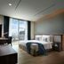 Shama Sukhumvit Bangkok guest room with city view, large bed, and floor-to-ceiling window in Bangkok