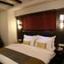 Sri Nanak Continental Hotel in New Delhi: double bed with patterned headboard, bedside lamps and AC in room